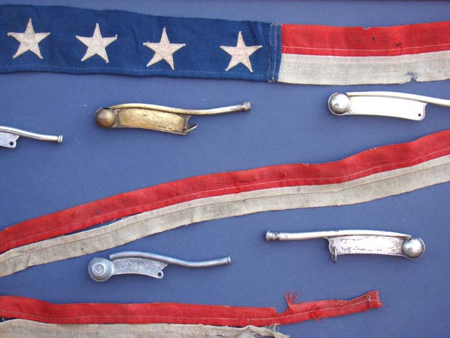 A framed collection of 8 bosuns' whistles and a ships pennant — image 2